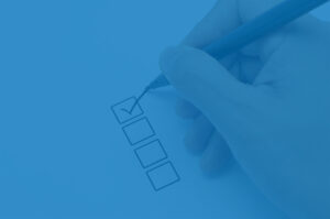 Hand filling out a checklist