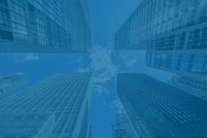 Ground view looking up at tall city buildings to represent investing during inflation and stagflation