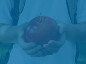 Student holding an apple - college savings metaphor