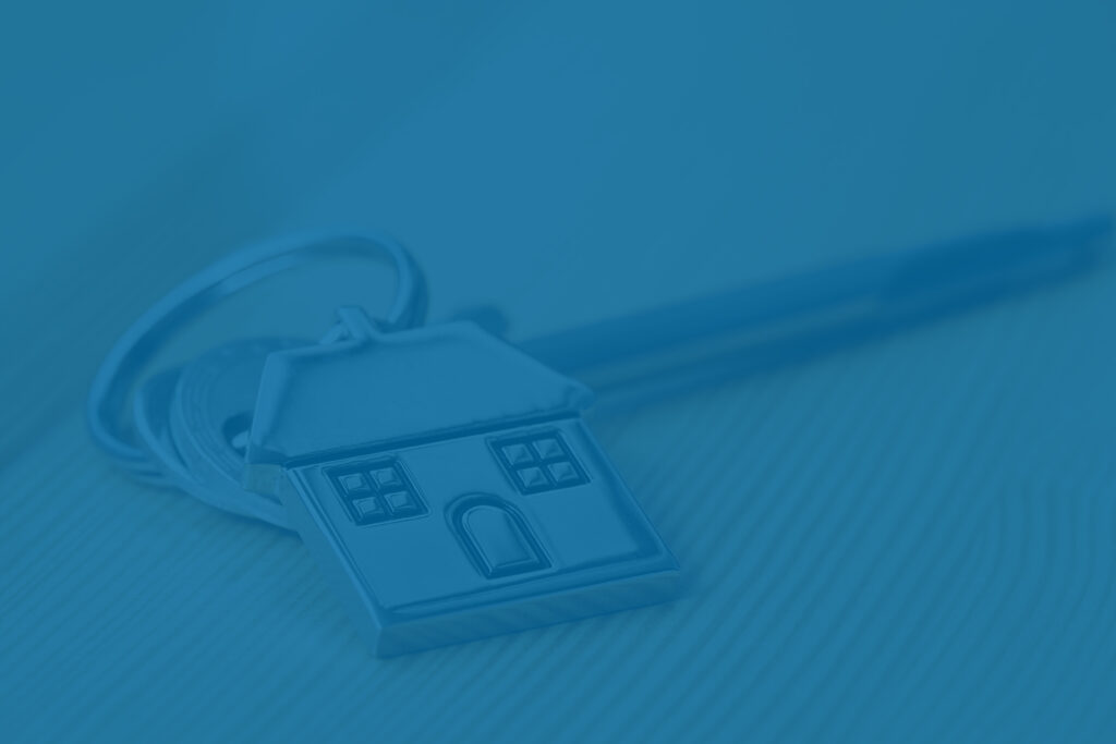 house key and pen to represent rental property - NIIT tax concept