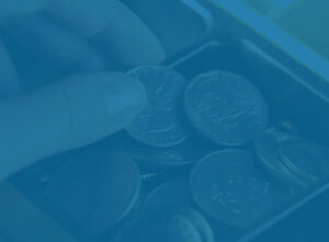 Business Owner taking coins from cash register - Profit First method representation