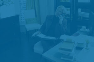 Woman working in home office, representing treating investments like a business.