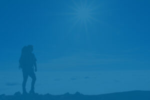 Hiker atop a mountain, representing financial independence