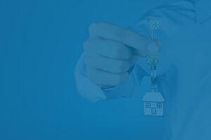 Real estate investor holding key, concept for unlocking infinite returns.