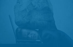 Businessman smashed by boulder, representing IRS audits