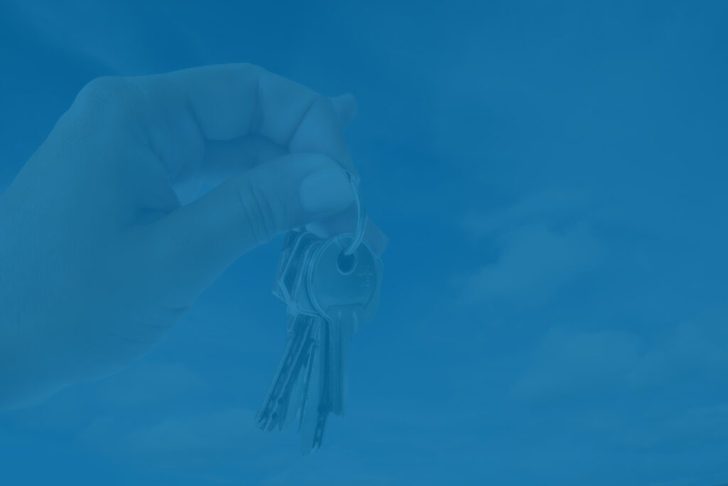 House keys held in the sky, mortgage questions concept. What to ask your mortgage lender.