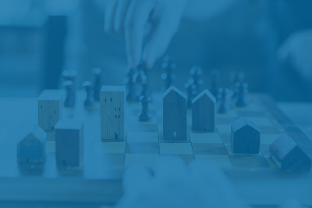 Real estate chess concept, representing investing during interest rate cut.